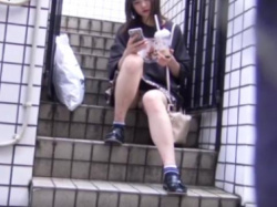【パンチラ】階段に座りこんでスマホを触っているお姉さんのパンティの画像